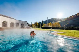 Wellness & Thermal spa - 3 nights Couple relaxing in heated outdoor pool with mountain scenery in background