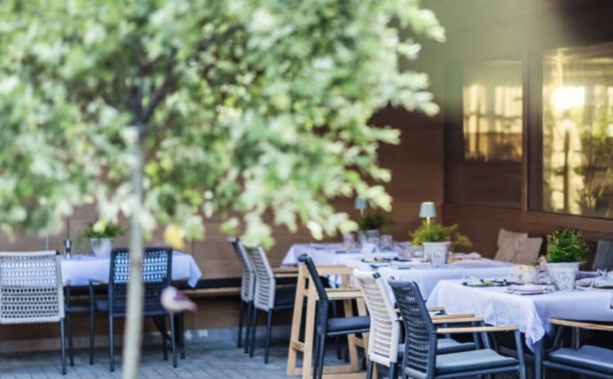 Outdoor terrace with set tables and chairs at a restaurant