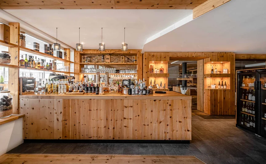 Modern wooden bar area with spirits and wine fridge