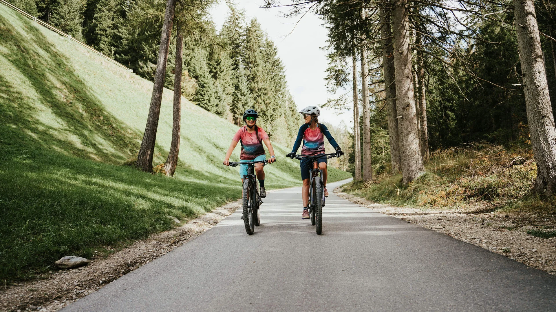 Spätsommer- & Herbstbiken in Toblach © Desire Lines - Tobias Dörr Zwei Personen fahren mit Mountainbikes auf Waldweg