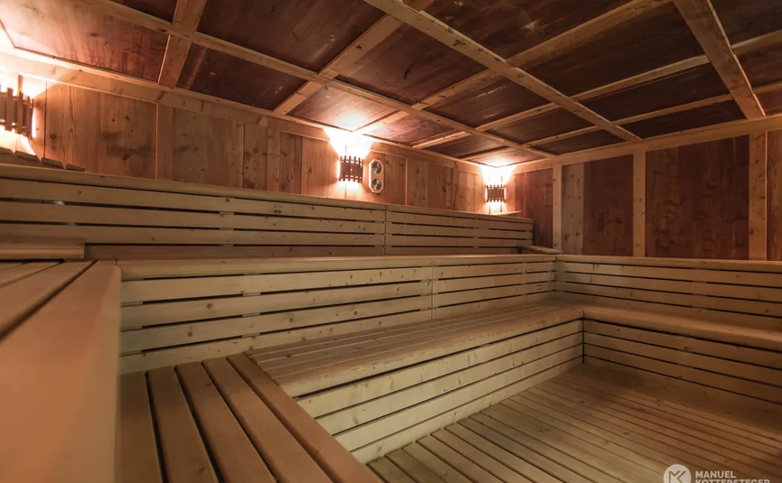 Interior of an empty wooden sauna with tiered benches