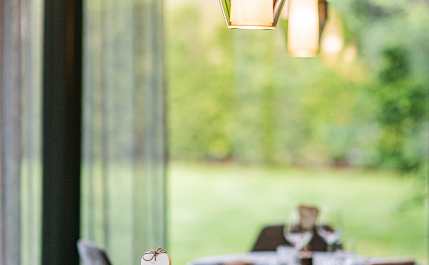 Elegant set dining table in modern restaurant with warm lighting