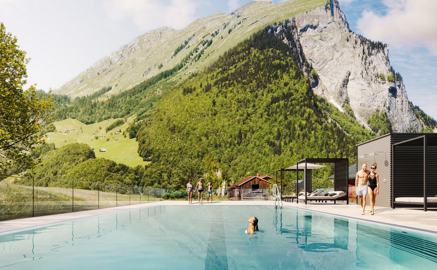 Swimming pool with mountain backdrop and people in swimwear