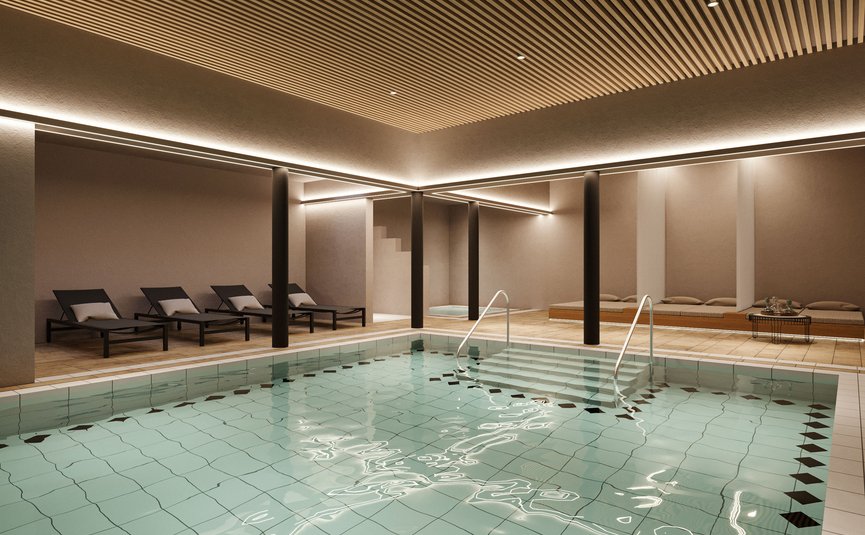 Indoor pool with loungers and warm lighting in a spa area