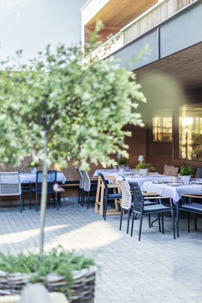 Moderne terras met gedekte tafels en stoelen in de buitenlucht