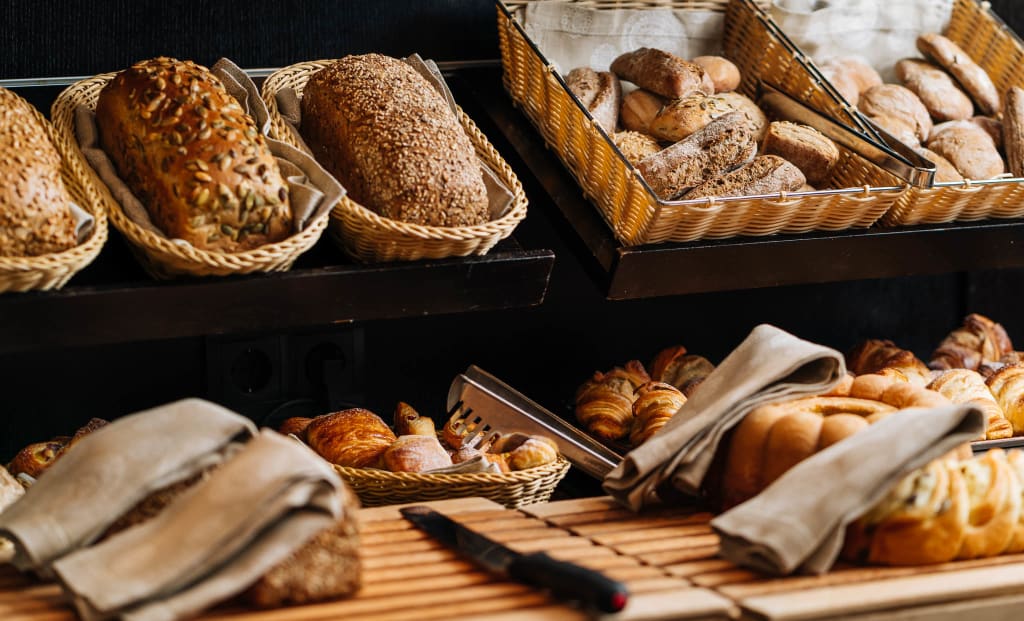 Various breads and pastries in baskets at a bakery